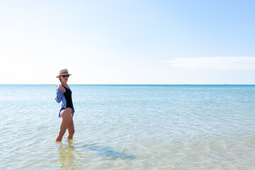 Woman in black swimsuit on the beach