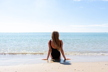 Woman in black swimsuit on the beach