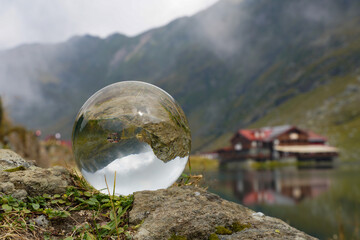 mountain and lake landscape with glass globe