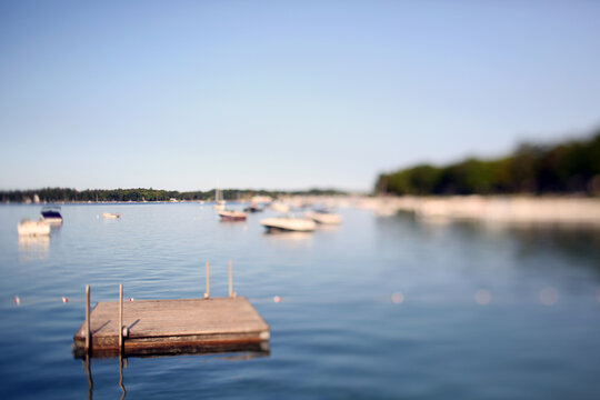 A Peaceful Bay With A Floating Dock and Boats On A Calm Summer Morning