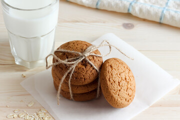 Oatmeal cookies and milk in glass, healthy snack.
