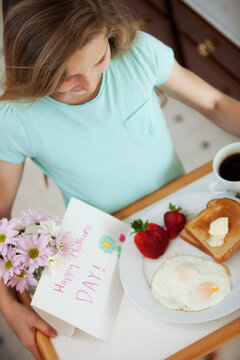 Mother's Day: Girl Bringing Mother Breakfast in Bed