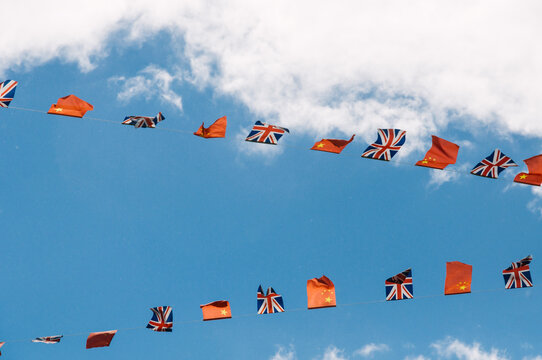 a string of British and Chinese flags fluttering in the breeze