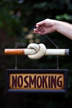 Man holding no smoking sign