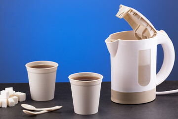 lovely compact electric kettle with cups and travel spoons