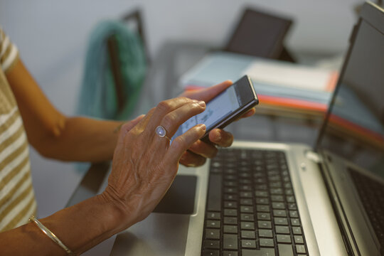 Closeup of hand's woman touching smart phone screen.
