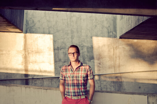 Young stylish man in parking lot with plaid shirt