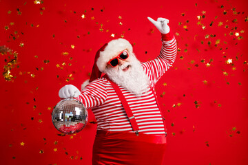 Photo of pensioner old man grey beard hold retro disco ball dance raise finger wear santa x-mas...