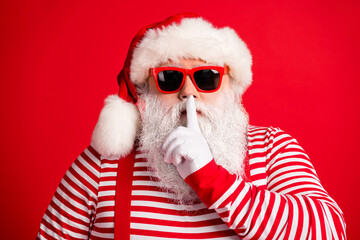 Close-up portrait of his he nice handsome mysterious white-haired Santa wearing sunglasses showing...