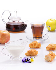 very beautiful tea with milk, pastries and flowers