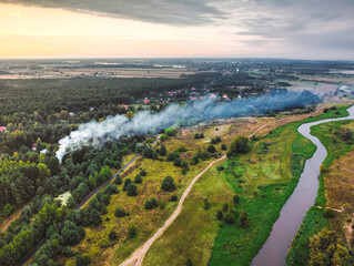 Smoke from the fire over cottages in the forest. Drone, aerial View.