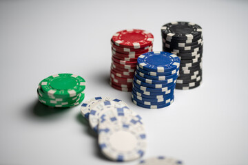 Stacked poker chips with one stack fallen