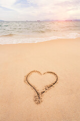 heart drawn in the sand on the beach. Romantic design element.