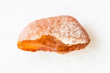 closeup of sample of natural mineral from geological collection - rough Amber gemstone on white marble background from Baltic Sea, Kaliningrad, Russia