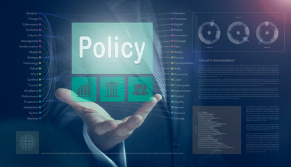 Businessman outreached hand holding a Policy business concept on a computerised screen display.