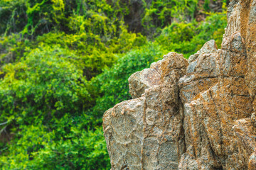 Beautiful natural summer composition landmark background. Bright vivid orange brown yellow stone rock shabby cliff cracks texture mountains. Concept of geolog, sea tourism cruise, power in nature