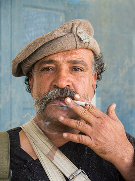 A Cigarette Smoking Tribal Man With Mustaches .