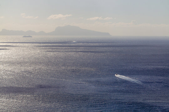 Idyllica view on sescape with Capri iland ans small and big boats in the Gulf of Naples