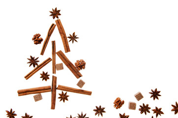Christmas tree made of cinnamon sticks anise and sugar cubes on white background