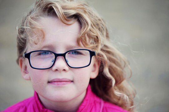 Young girl with glasses and blond curls