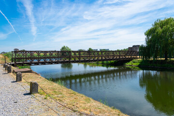 Fototapeta na wymiar Iron bridge over the water in the fortress of Breendonk, Belgium