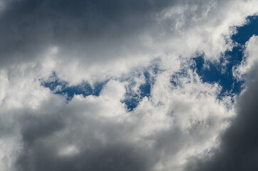 Storm clouds in a blue sky with a gap