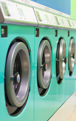 Washing machines in a turquoise green laundry room