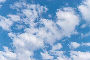 Blue sky and white and fluffy clouds, background and pattern