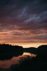 Obraz premium pink sunset over the river in the forest