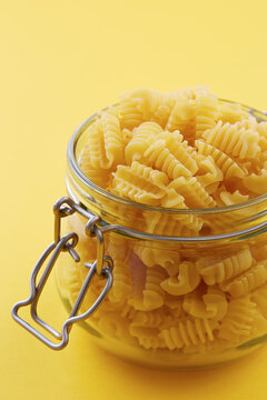 Raw radiatori pasta on a glass jar