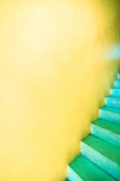 Bright yellow entrance with turquoise stairs