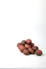 a pile of potatoes isolated on white background. Harvesting concept. Vertical image