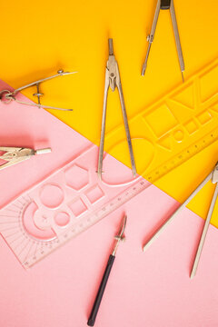 Simple accessories for geometry work on yellow-pink background.