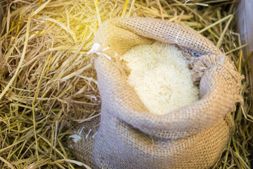 Raw Thai jasmine rice in the sag bag with vintage warm light, selective focus