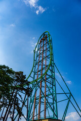 Roller coaster against a deep blue sky