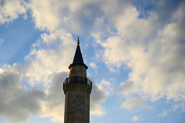 Fototapeta na wymiar The setting sun shines on the minaret of the Ar-Rahma mosque in Kyiv, Ukraine