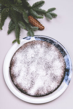 Homemade chocolate brownie almond cake on grey background. Gluten free flourless dessert. Winter christmas treat. Toned image