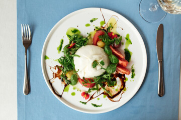 Spanish buratta salad with vegetables and greens