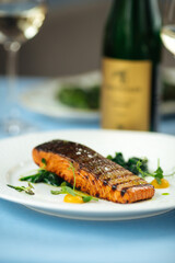 Grilled salmon fillet steak on the blue table