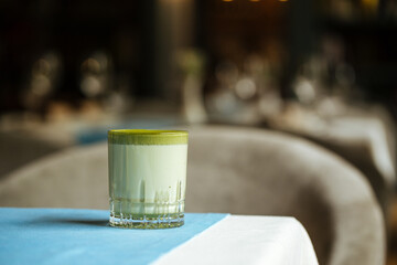 Matcha beverage in a glass on the restaurant table