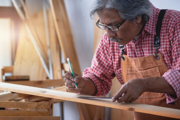 Asian senior carpenters working in the workshop, concept of wood working