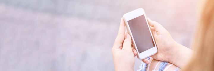 Beautiful american portrait of schoolgirl. Preschool kid hold device. Little happy girl outdoors. Pretty female person. Adorable candid children. Near building. Education online. Mobile phone. Mockup