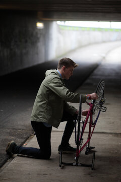 Young man with vintage bicycle in an urban bike tunnel