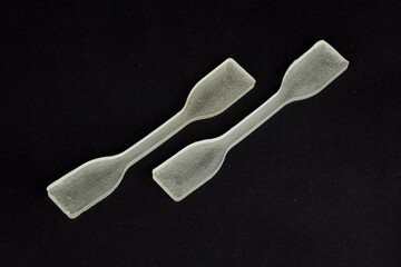 polydimethylsiloxane (pdms) polymer sample which is using in engineering experiments. it is a tensile test specimen to examine the strength of the material.