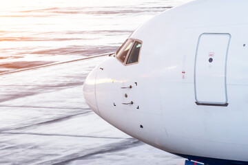 Widebody commercial jet airplane cockpit with door for entry-exit, side view.