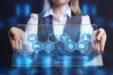 Business, Technology, Internet and network concept. Young businessman working on a virtual screen of the future and sees the inscription: Outsourcing