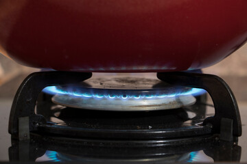 a red pan on the cooker. macro or close up photo