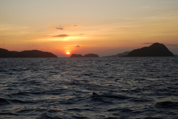 sunset over the sea on background of the islands on the distance