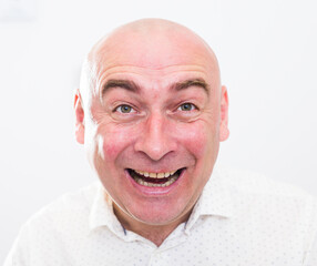 portrait of bald adult mature man with emotions on white background