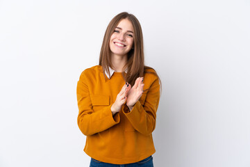 Young woman over isolated white background applauding after presentation in a conference